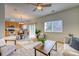 Open-concept layout featuring a well-lit living area, dining space, and kitchen with stainless appliances at 7345 S Nucla St, Aurora, CO 80016