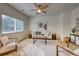 Bright living room with modern furnishings, neutral tones, and large windows at 7345 S Nucla St, Aurora, CO 80016
