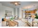 Spacious living area featuring modern decor, an open layout, and a view into the dining and kitchen areas at 7345 S Nucla St, Aurora, CO 80016