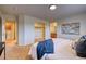 Spacious main bedroom featuring an ensuite bathroom, closet, carpet flooring, and natural light at 7345 S Nucla St, Aurora, CO 80016