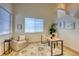 Cozy office featuring large windows, a comfortable chair, and stylish decor on an intricate rug at 7345 S Nucla St, Aurora, CO 80016