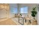 Inviting office area with ample natural light, a modern desk setup, and stylish chair near the entry at 7345 S Nucla St, Aurora, CO 80016