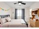 Bedroom features a bed, window, dresser and neutral walls at 11032 Cannonade Ln, Parker, CO 80138