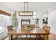 Bright dining room featuring a wooden table, modern chandelier, and fireplace, perfect for Gathering gatherings at 11032 Cannonade Ln, Parker, CO 80138