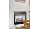 Close-up of the fireplace featuring a white surround and black trim in the dining room at 11032 Cannonade Ln, Parker, CO 80138