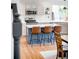 Modern kitchen with an island, seating, stainless steel appliances, and ample counter space for culinary enthusiasts at 11032 Cannonade Ln, Parker, CO 80138