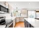 A bright kitchen with an island, stainless steel appliances, and an adjacent dining area with a view at 11032 Cannonade Ln, Parker, CO 80138