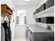 Bright laundry room features a utility sink, shelving, storage boxes and gray front load washer and dryer at 11032 Cannonade Ln, Parker, CO 80138