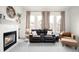 Cozy living room with a fireplace, plush seating, and soft lighting creating a relaxing atmosphere for unwinding at 11032 Cannonade Ln, Parker, CO 80138