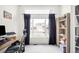 Bright home office featuring a large window, desk, and built-in shelving, creating an ideal workspace at 11032 Cannonade Ln, Parker, CO 80138