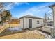 Backyard features a detached garage and small patio at 2800 Albion St, Denver, CO 80207