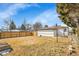 Expansive backyard featuring a wood fence and detached garage, perfect for outdoor enjoyment at 2800 Albion St, Denver, CO 80207