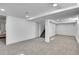 Finished basement features open layout, recessed lights, and stairs at 2800 Albion St, Denver, CO 80207