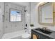 Modern bathroom featuring black vanity, gold accents, and unique geometric tile design creating a sleek at 2800 Albion St, Denver, CO 80207