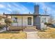 Charming home featuring brick accents, a covered porch, and well-maintained landscaping at 2800 Albion St, Denver, CO 80207