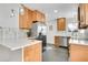 Well-lit kitchen with stainless steel appliances, light wood cabinets, quartz countertops and tile backsplash at 2800 Albion St, Denver, CO 80207