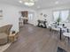 Bright living room featuring modern chandelier, hardwood floors, and an open layout with adjacent kitchen at 2800 Albion St, Denver, CO 80207
