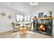 A cozy living room featuring fireplace, hardwood floors, and chandelier lighting at 2800 Albion St, Denver, CO 80207