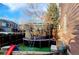 Backyard featuring a trampoline with safety net, creating a fun outdoor space for recreation at 5405 S Sicily St, Aurora, CO 80015