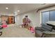 Spacious basement featuring a sauna, dollhouse and comfortable seating area at 5405 S Sicily St, Aurora, CO 80015
