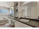 Bright bathroom with a double vanity, decorative mirror, and ample counter space at 5405 S Sicily St, Aurora, CO 80015