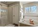 Bright bathroom with a walk-in shower, soaking tub, and natural light at 5405 S Sicily St, Aurora, CO 80015