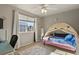 Bright bedroom featuring a stylish tent bed, large window, and comfortable furnishings at 5405 S Sicily St, Aurora, CO 80015