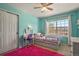 Bright bedroom with an abundance of natural light, desk, and a playful pink rug at 5405 S Sicily St, Aurora, CO 80015