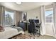 Cozy bedroom with a study area, large windows, and comfortable neutral toned furnishings at 5405 S Sicily St, Aurora, CO 80015
