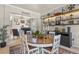 Bright dining room with a wooden table, stylish decor, and an open view to the study room at 5405 S Sicily St, Aurora, CO 80015