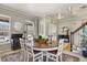 Inviting dining area featuring hardwood table, stairs to second floor, and bright natural light at 5405 S Sicily St, Aurora, CO 80015