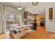 Bright kitchen and dining area with hardwood floors, updated appliances, and access to the backyard deck at 5405 S Sicily St, Aurora, CO 80015