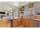 Open-concept kitchen with wood floors, modern appliances, and a view of the living area at 5405 S Sicily St, Aurora, CO 80015