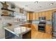 Well-lit kitchen featuring modern appliances, ample counter space, and natural wood cabinetry at 5405 S Sicily St, Aurora, CO 80015