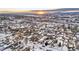 Aerial view of a residential neighborhood with snow-covered homes and streets at 141 N 5Th Ave, Brighton, CO 80601