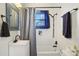 Clean bathroom with white tile, a tub, and a vanity with a sink at 141 N 5Th Ave, Brighton, CO 80601