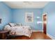 Light blue bedroom with wood floors and a comfortable double bed at 141 N 5Th Ave, Brighton, CO 80601