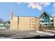 Exterior view of Southeast Elementary School building, flagpole, and entrance at 141 N 5Th Ave, Brighton, CO 80601