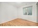 Bedroom with hardwood floors and window with exterior AC unit at 1610 N Humboldt St # 1/2, Denver, CO 80218