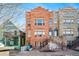 Three-story row house featuring red and gray stone facade with large windows and a stoop entrance at 1610 N Humboldt St # 1/2, Denver, CO 80218