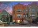 Three-story row house featuring red and gray stone facade with large windows and a stoop entrance at 1610 N Humboldt St # 1/2, Denver, CO 80218