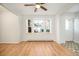 Bright living room featuring hardwood floors and three large windows, with a ceiling fan at 1610 N Humboldt St # 1/2, Denver, CO 80218