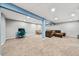Finished basement featuring neutral carpet, gray walls, and support beams at 16650 E Nassau Dr, Aurora, CO 80013