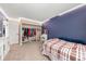 Bedroom featuring a closet, full bed, vanity and mirror and neutral carpet at 16650 E Nassau Dr, Aurora, CO 80013
