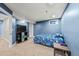Bedroom featuring blue walls, neutral carpet, and a full bed at 16650 E Nassau Dr, Aurora, CO 80013