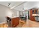 Open dining area with hardwood floors, granite island, and natural light at 16650 E Nassau Dr, Aurora, CO 80013