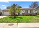 Charming single-story home featuring a well-manicured lawn, brick accents, and a quaint covered front entrance at 16650 E Nassau Dr, Aurora, CO 80013