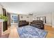 Open concept living room with hardwood floors, fireplace, and view to the dining area at 16650 E Nassau Dr, Aurora, CO 80013
