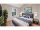 This bedroom features a gray headboard, blue pillows, and a view of the mountains out the window at 10329 W Fair Ave # C, Littleton, CO 80127