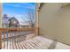 Exterior deck view showcasing wood railings, and a glimpse of neighboring houses at 10329 W Fair Ave # C, Littleton, CO 80127